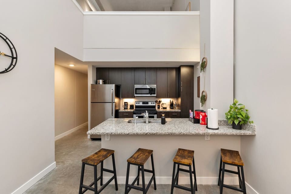 Kitchen area w/ all appliances, cookware, breakfast bar with stools & free coffee bar