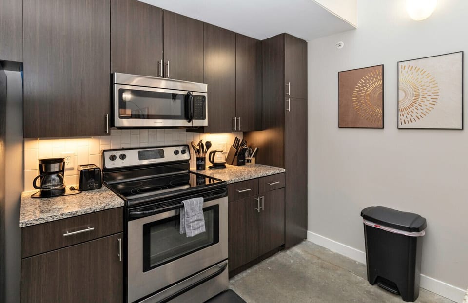 Kitchen area w/ all appliances, cookware, breakfast bar with stools & free coffee bar