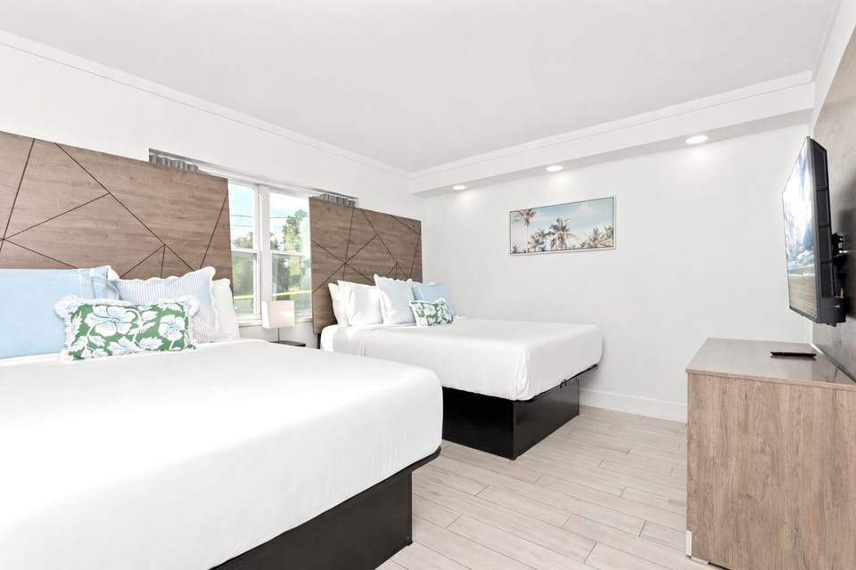 Second bedroom in this two-bedroom suite offers two comfortable queen beds, coastal-inspired décor, crisp linens, and a bright, relaxing space ideal for guests or family.
