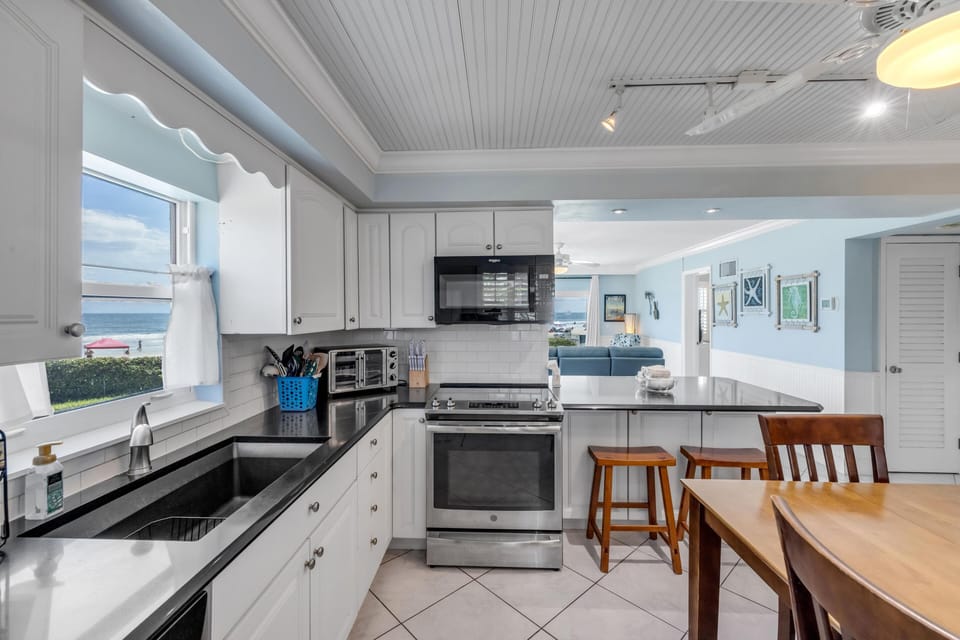 Bright, modern kitchen with ocean views and cozy dining area