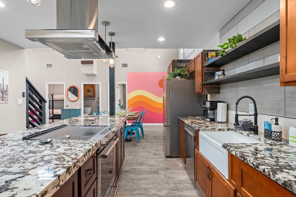 Wide-open kitchen flows straight into the fun: cook, chat, and keep an eye on the game room action all at once.