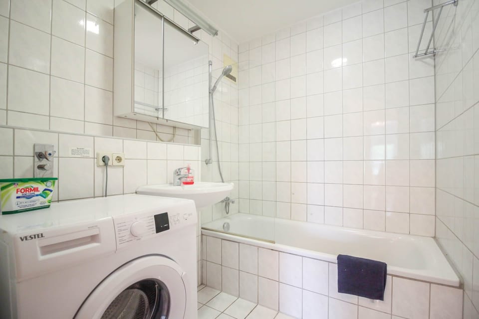 Bathroom with bathtub and washing machine