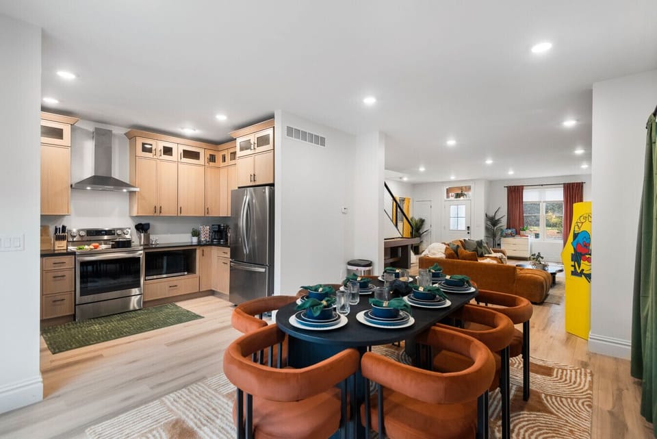 Dining Room: Highlights include contemporary designer seating, an open-concept layout to the kitchen, and abundant natural light. Enjoy a seamless flow between cooking and dining in this bright, stylish space.