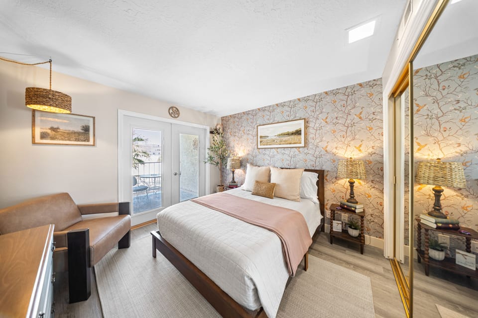 Beautiful primary suite with French doors opening to the private balcony