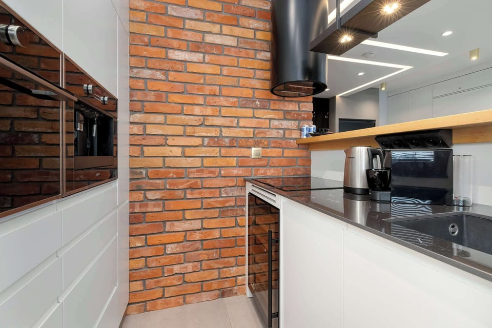 The sleek design of the kitchenette blending seamlessly with the living area.