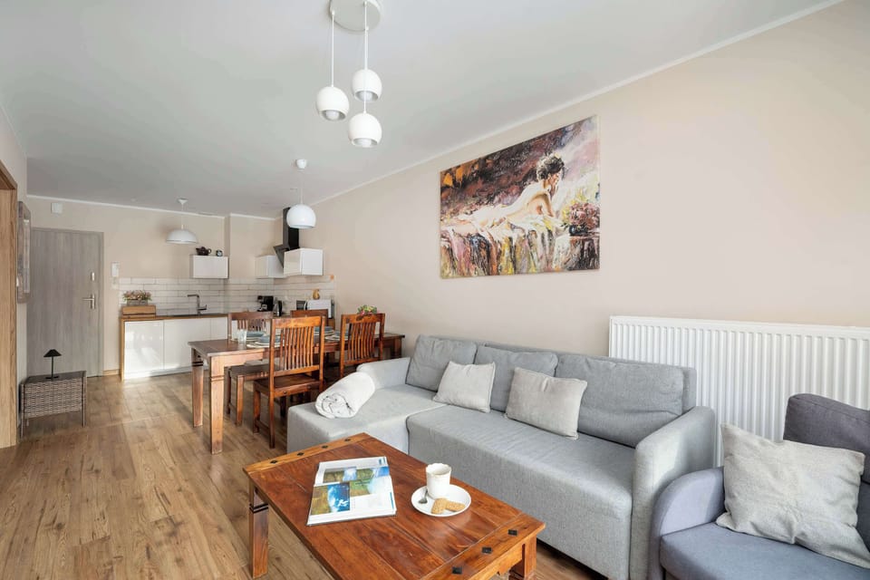 Inviting living area with a comfortable grey sofa, coffee table, and tasteful wall décor.