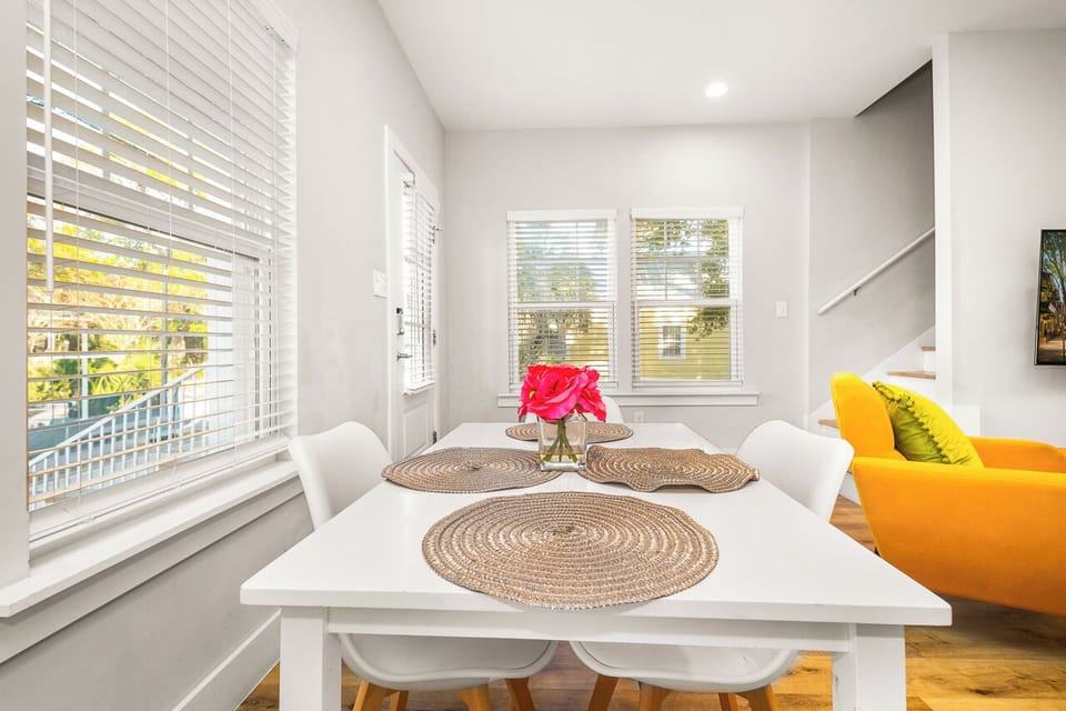 Enjoy meals in your bright, modern dining space with natural light streaming through windows and stylish touches throughout.