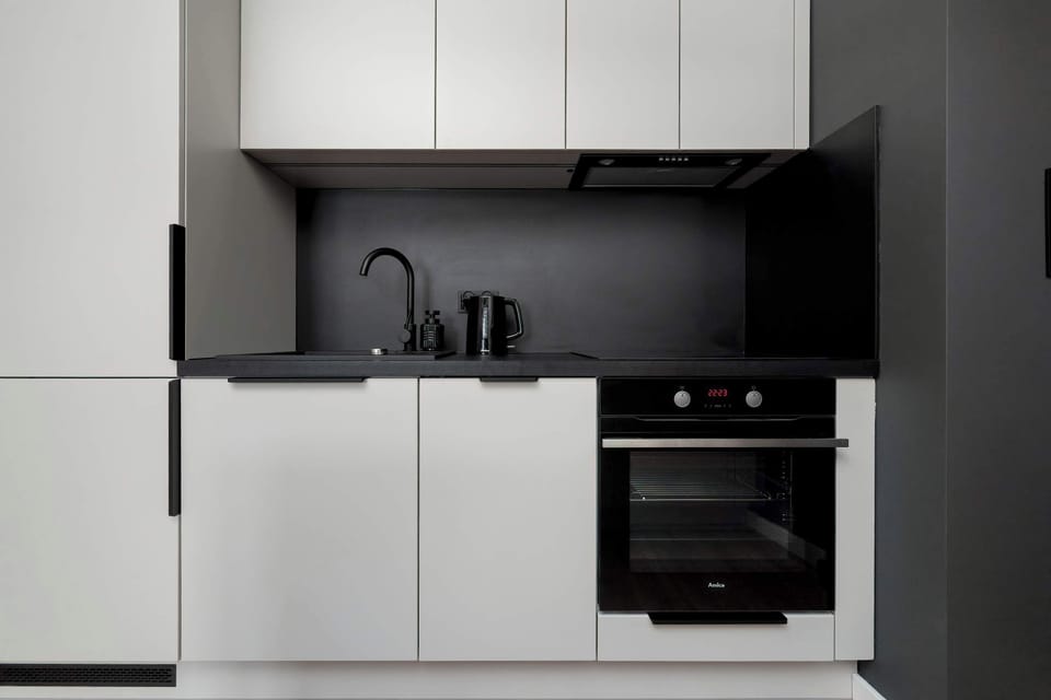 The sleek design of the kitchenette blending seamlessly with the living area.