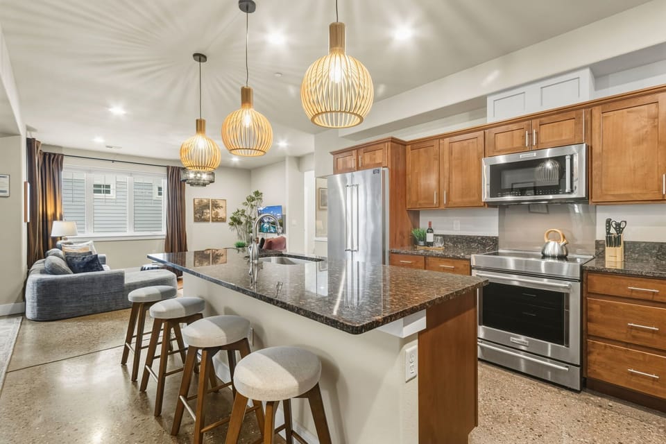 Your spacious open-plan kitchen flows beautifully into the living area, perfect for socializing while cooking with granite counters and modern appliances.