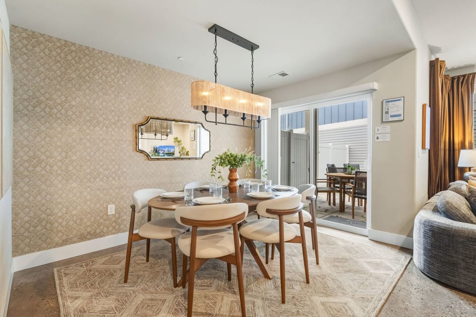 Gather around this elegant dining table where warm lighting and thoughtful touches create perfect moments for sharing meals with loved ones.