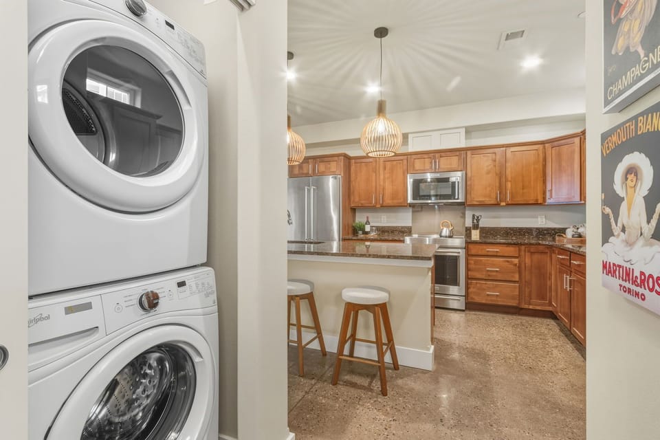Your in-unit washer and dryer make extended stays effortless, while the modern kitchen with granite counters beckons for home cooking adventures.