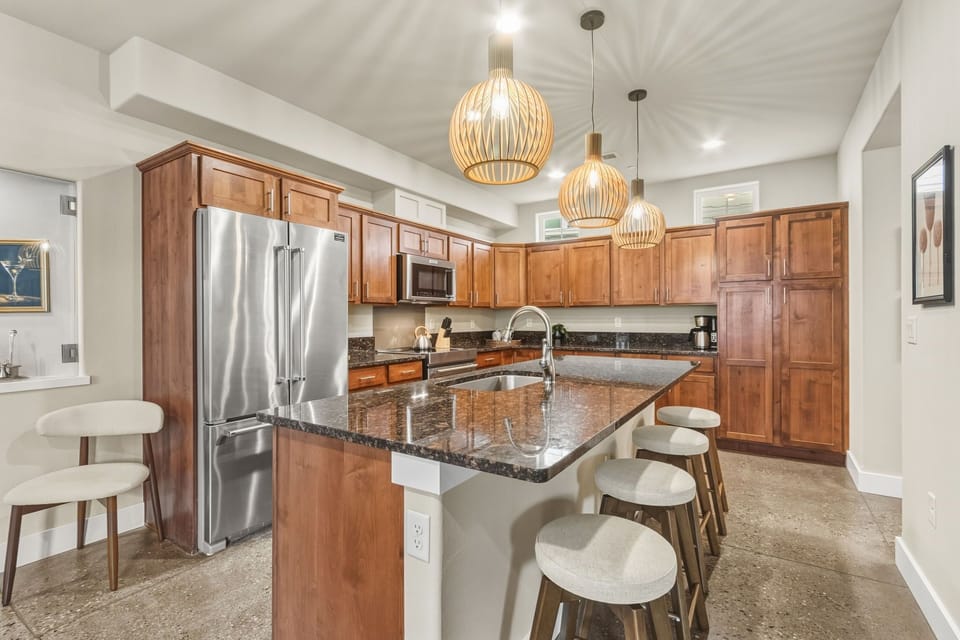 Your gourmet kitchen awaits with rich wood cabinetry, granite countertops, and a spacious island where you'll create memorable meals together.