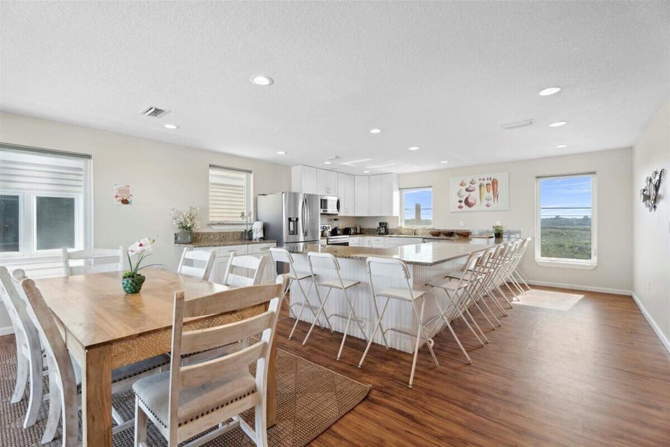 Oceanfront kitchen with island seating and panoramic beach views. 🌊🍽️