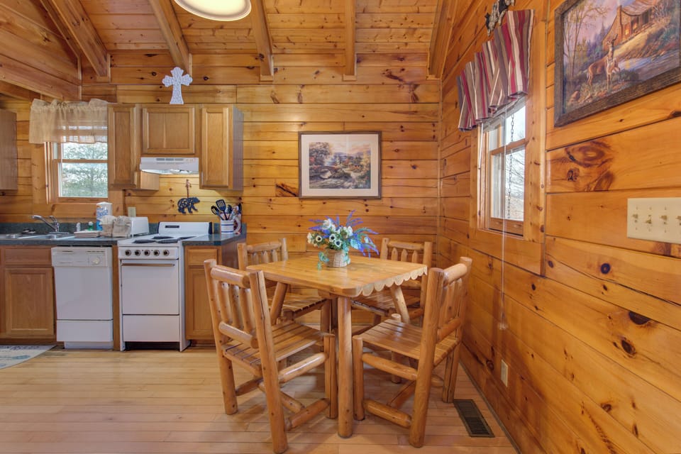 Gather around your rustic wooden table in this cozy log cabin kitchen, where warm wood surrounds you and sunlight streams through windows.