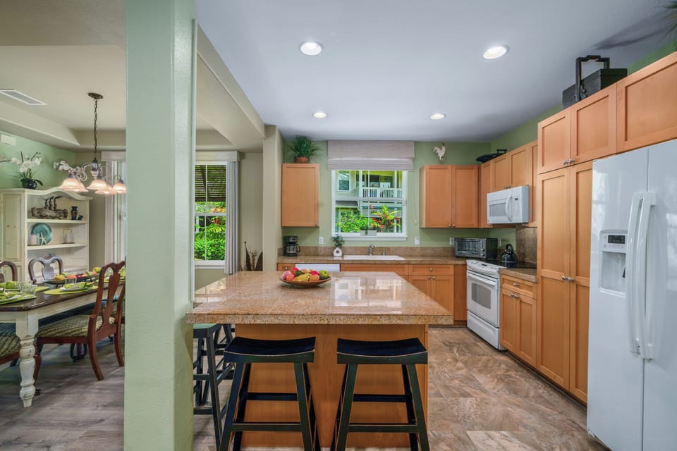 Cook memorable meals in your spacious kitchen featuring granite countertops, modern appliances, and a convenient breakfast bar perfect for morning coffee.