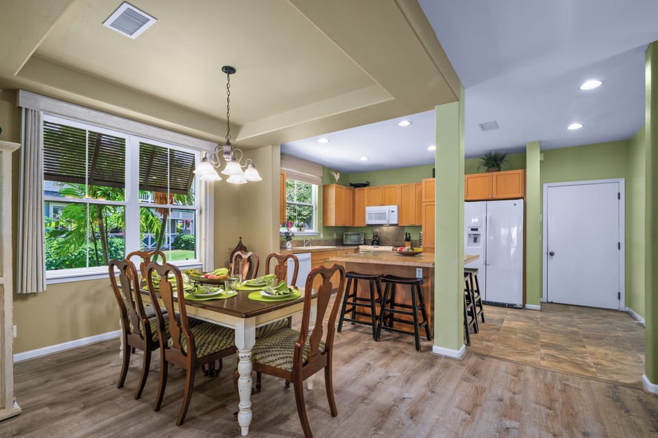 Gather around this inviting dining table where your group can share meals and make memories in this bright, open-concept space.