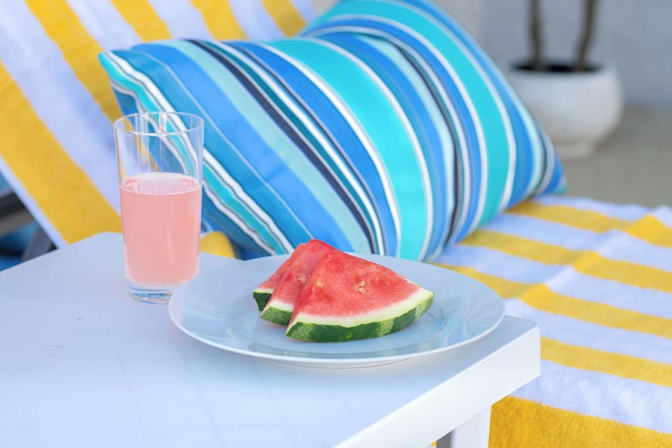 Shared outdoor pool with comfortable sun loungers for relaxing and soaking up the sun. 