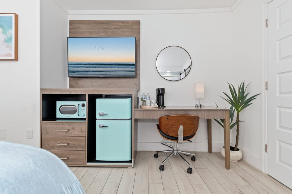 Comfortable queen bed with crisp linens, air conditioning, heating, TV, clothing storage, and room-darkening shades. Extra pillows and blankets provided for a restful stay.