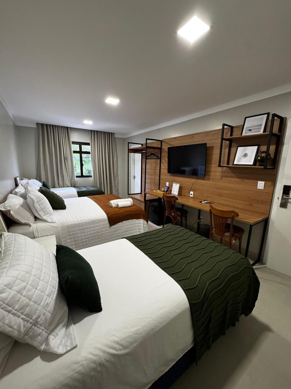 Premium Triple Room | Minibar, desk, laptop workspace, blackout drapes