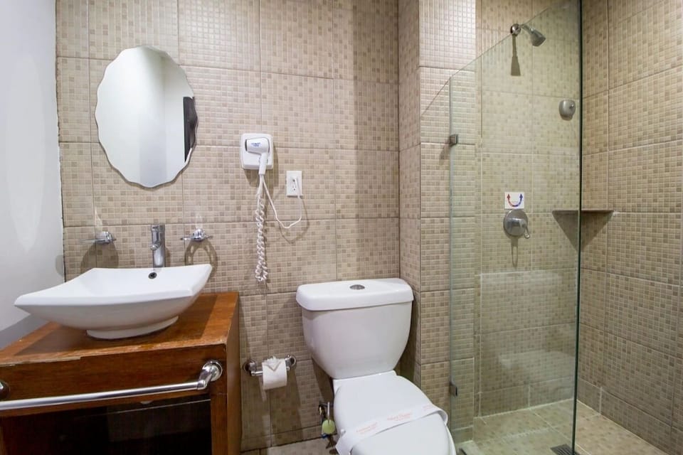 Rinse off comfortably in a bright, modern tiled shower space