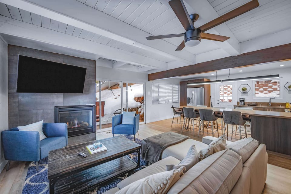 Living area with sectional sofa, gas fireplace, and Smart TV