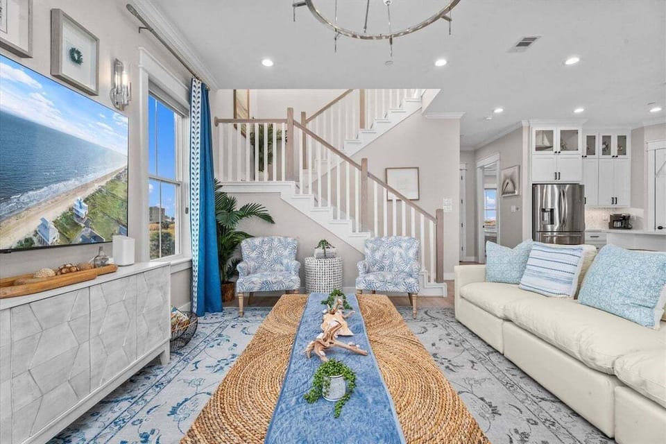Living space with accent rug, upholstered seating, and open layout connecting to dining area.