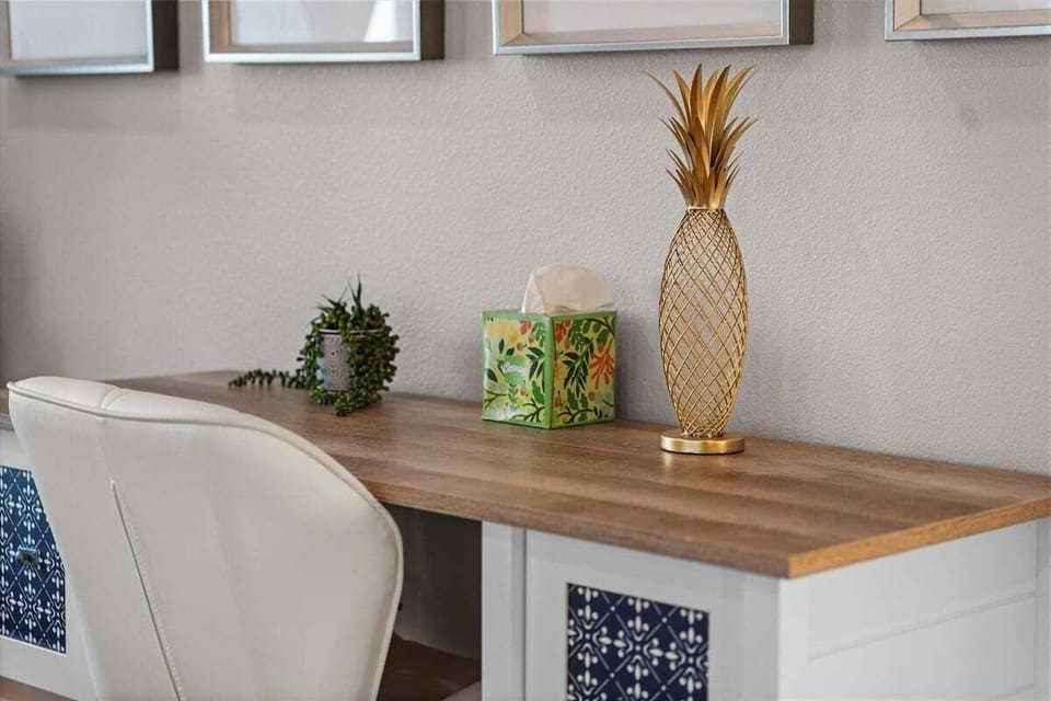 Bedroom workspace nook with desk area, decorative accents, and natural lighting.