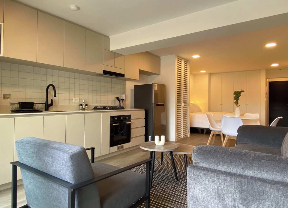Living area with sofa and kitchen seamlessly connected.