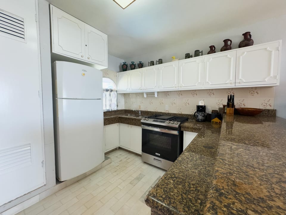 Bright kitchen with granite countertops and ample storage