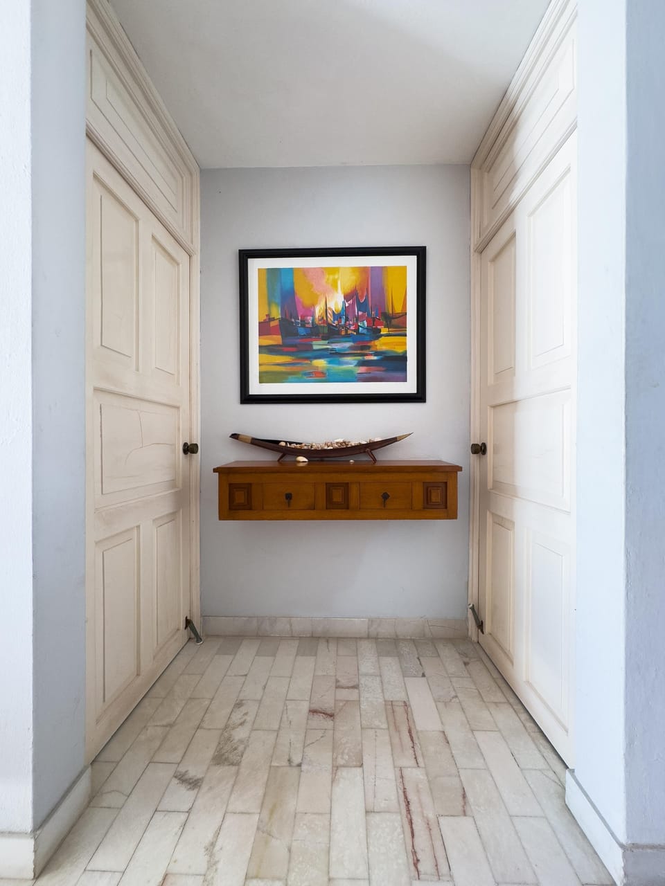 Bright, airy hallway with modern art and sleek storage