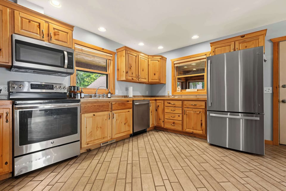 Modern, fully-equipped kitchen with stainless steel appliances and ample counter space for preparing group meals.