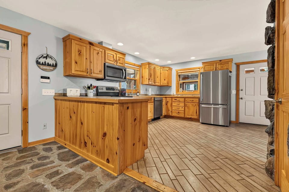 Fully equipped open-concept kitchen featuring modern appliances and ample space for preparing any meal.