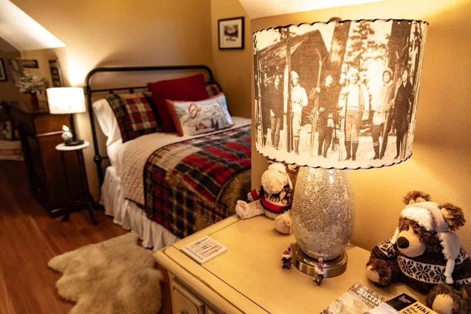 The double room is the most charming space with a queen and full bed, mountain themes, a private ensuite, electric fireplace, and privacy.