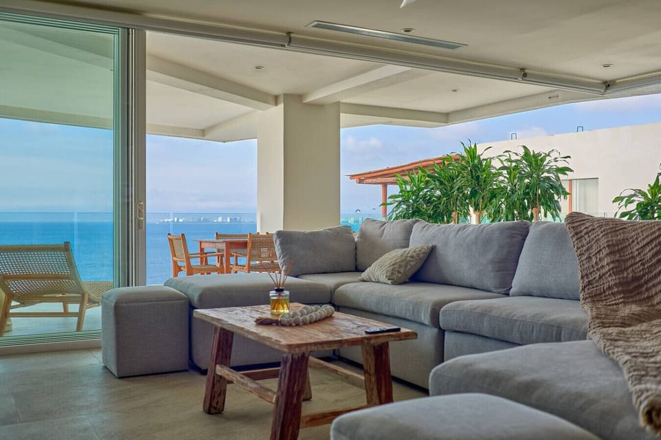Breathtaking ocean views from the comfort of your living room. This open-concept space seamlessly connects to a private terrace with outdoor dining, inviting you to relax and soak in the beauty of Puerto Vallarta’s coastline.