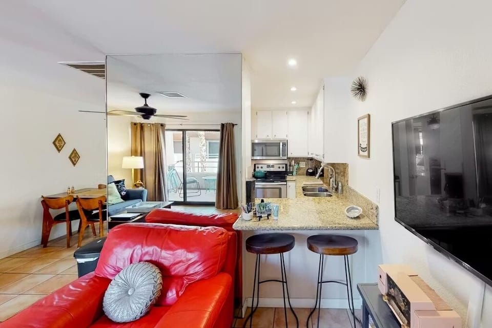 Updated kitchen with granite counters, bar seating, and stainless appliances