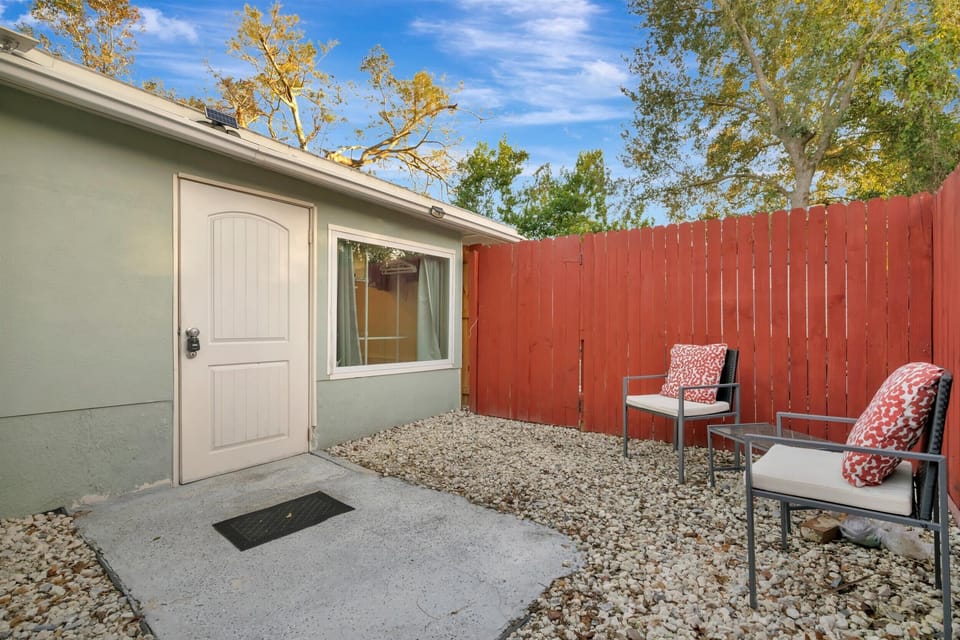 Private patio seating in a fenced backyard
