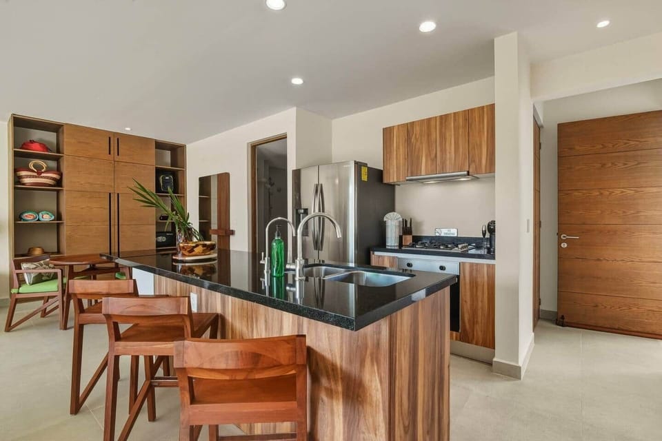 Cook with ease in the fully equipped kitchen featuring a microwave, stove and oven, blender, toaster, and coffee machine, plus filtered drinking water and ice and all the essentials needed to make a meal.