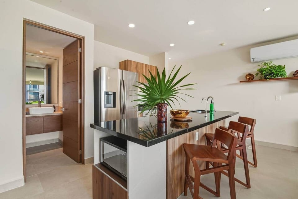 Enjoy the kitchen island with seating for three, perfect for meals or casual bites, with the microwave conveniently located right beside the island.