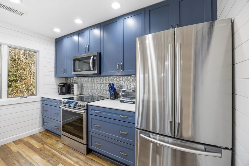 The fully equipped kitchen features modern appliances, ample counter space, and everything needed to prepare meals at home.