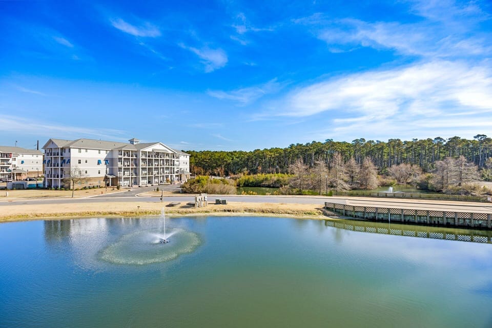 The rear deck offers peaceful water views of the pond and surrounding landscape, creating the perfect spot to enjoy morning coffee or evening relaxation.