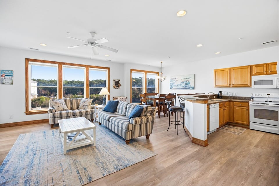The main living area features a gas fireplace, flat-screen TV, and comfortable seating, creating a welcoming space for family or friends to gather.