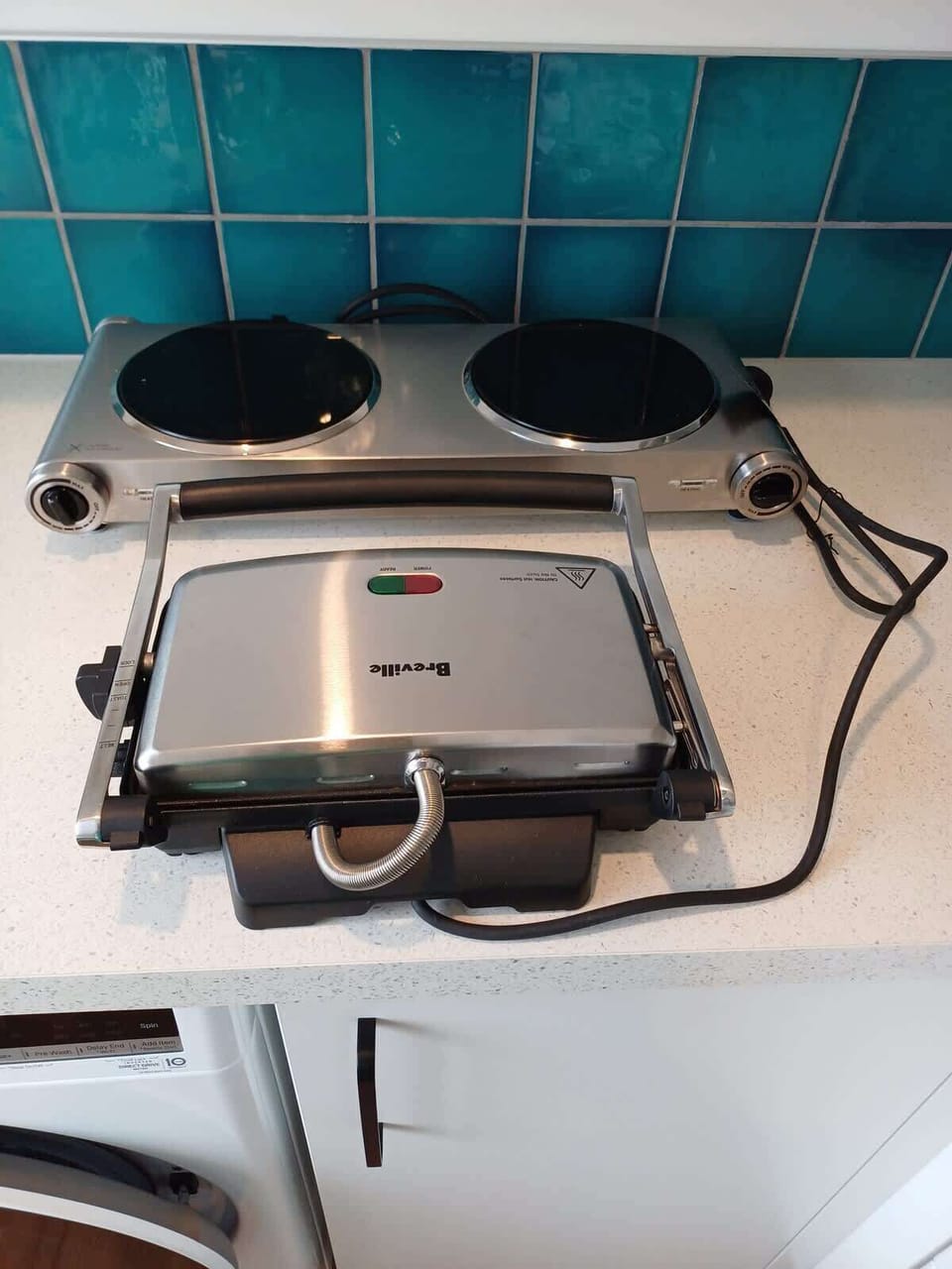 A sandwich press and small cooktop are available to use.
