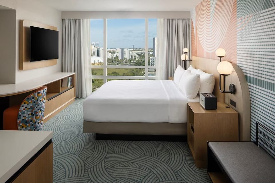Wake up to skyline views from a plush king bed.
