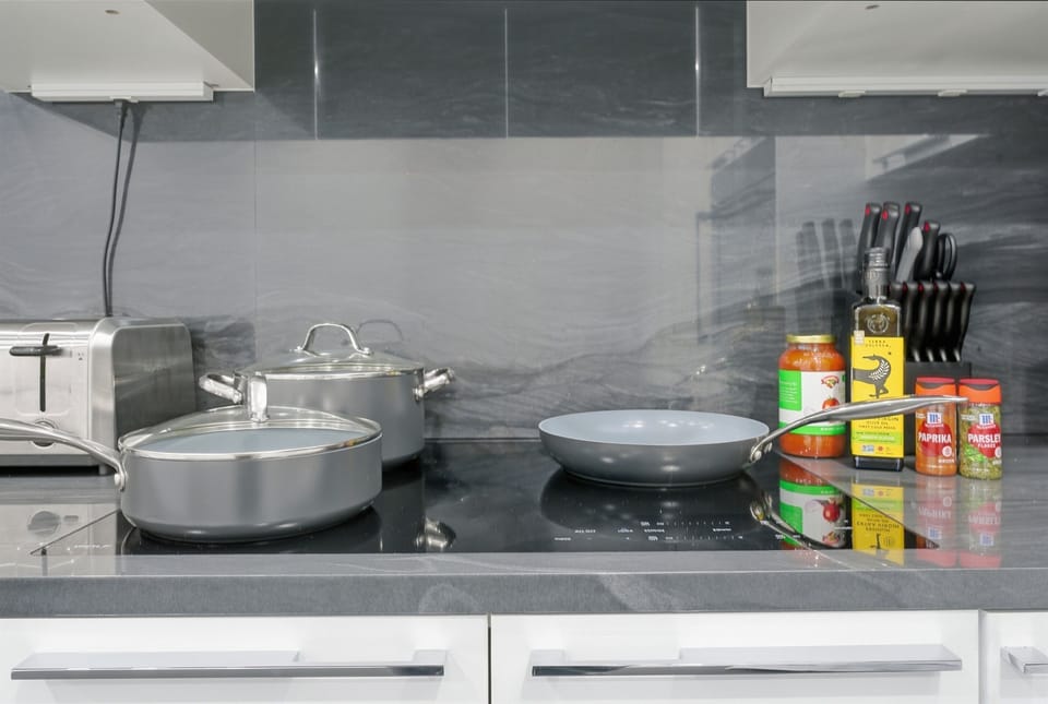 Professional-grade Wolf induction cooktop with specialized magnetic cookware provided. Experience rapid, precise heating for your vacation meals. We provide essential oils and spices to ensure a seamless chef's experience in Bar Harbor.
