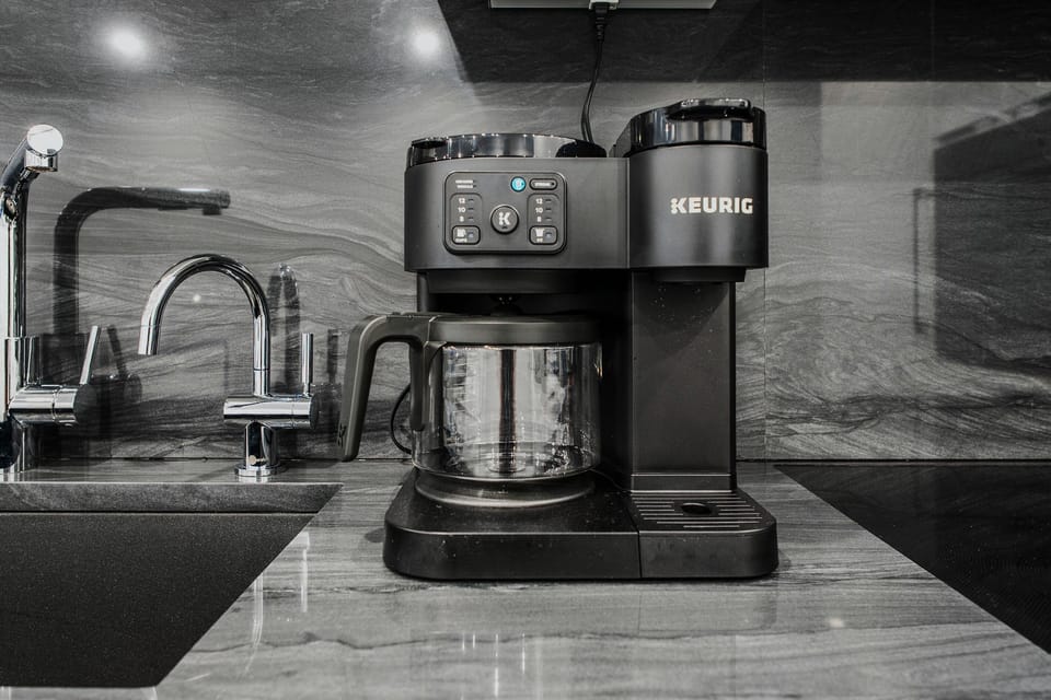 Brew it your way before exploring Acadia National Park. The kitchen features a Keurig Duo coffee maker, supporting both single-serve pods and a full 12-cup drip carafe. Located right next to the sink with a dedicated filtered water faucet.