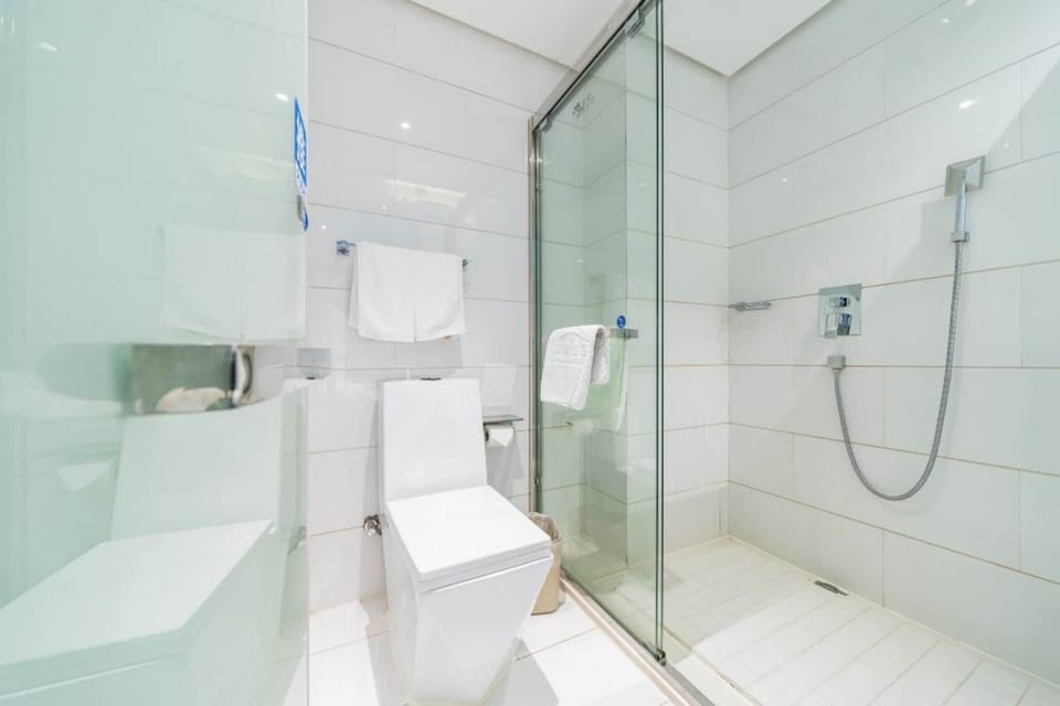 Shower, hair dryer, slippers, towels