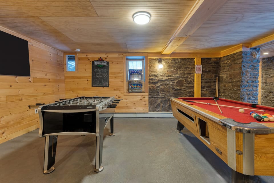 Game room highlighting the stone masonry and entertainment options.