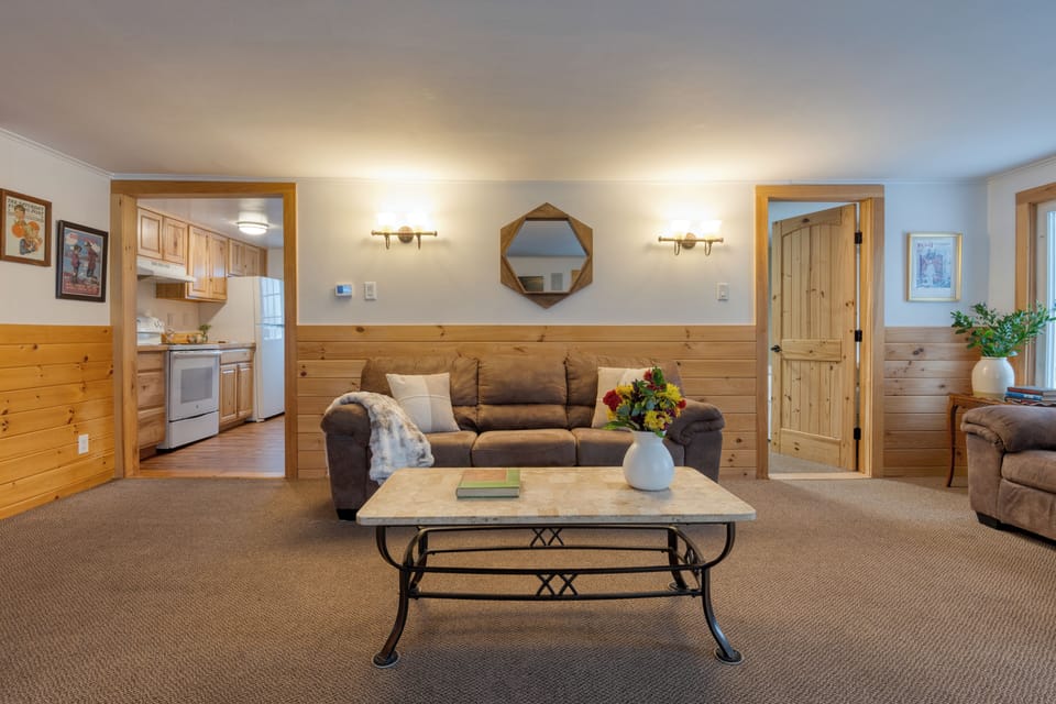 Secondary living room with comfortable seating and a fireplace.