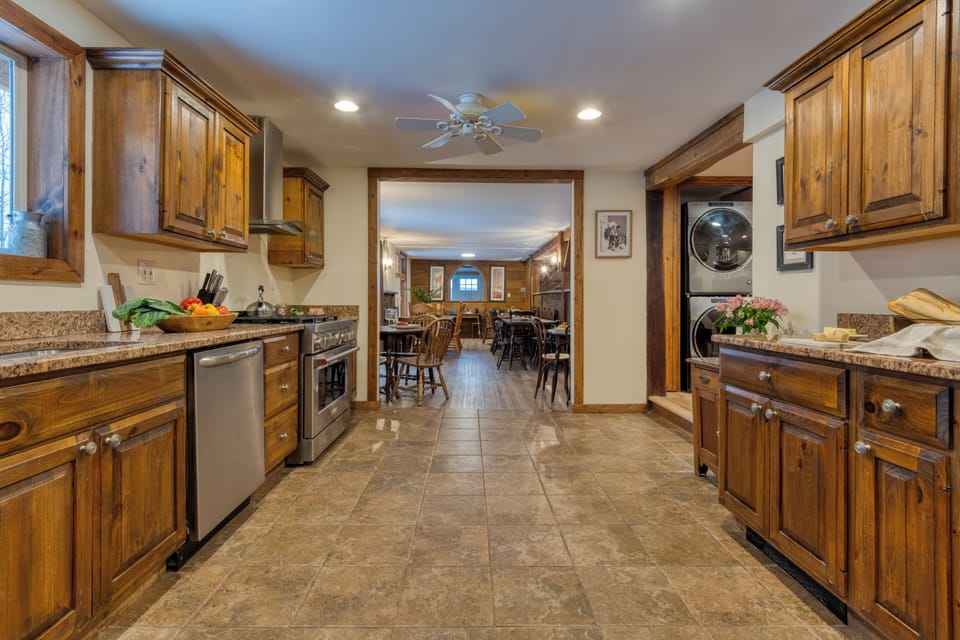 Fully equipped kitchen with wooden cabinetry and a gas stove.
