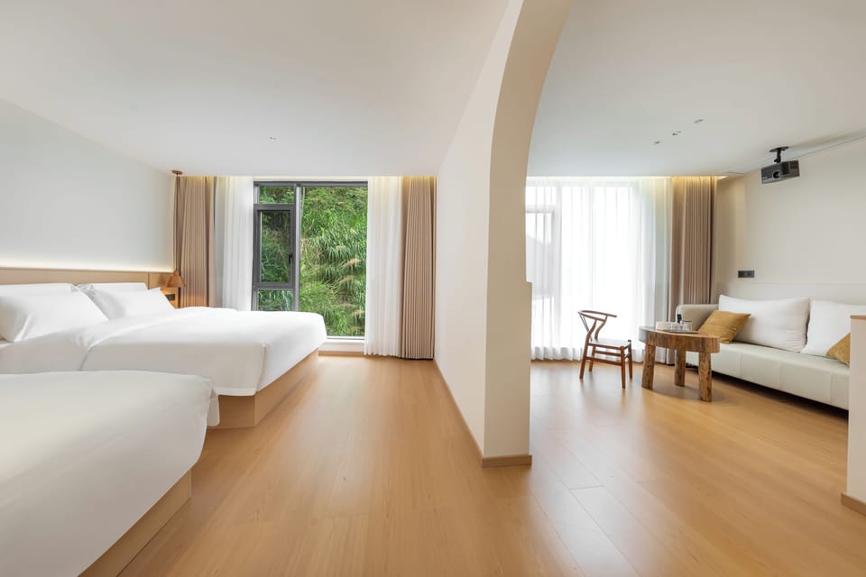 Luxury Suite, Courtyard View | Laptop workspace, blackout drapes, soundproofing, iron/ironing board